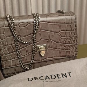 Decadent green embossed leather handbag with silver color chain....new